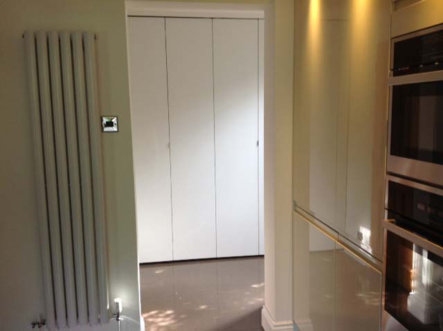 image shows: The utility room is finished and sits neatly behind its folding screen